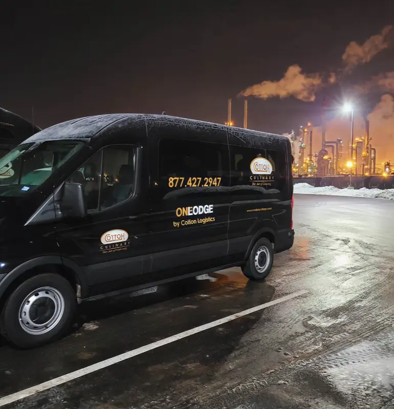 Cotton Logistics van parked in a parking lot in front of a chemical plant.